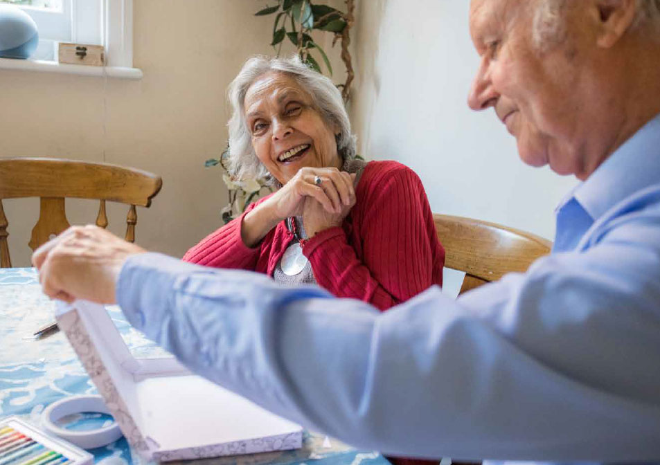 A Zest at Home participant sat at a table with a loved one